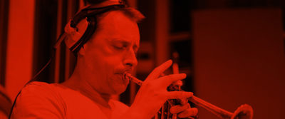 A solo trumpet player recording at AIR studios for the Spitfire Studio Brass collection.