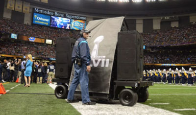 An image of speakers getting rolled on/off the field at the Super Bowl. Image by Patrick Baltzell.