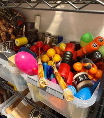 A picture of a tub of percussion instruments.